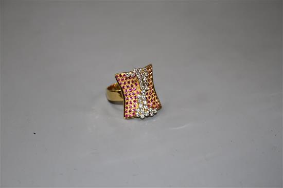 A modern yellow metal (etched? 18k), pave set ruby and diamond dress ring, size N, gross 10 grams.